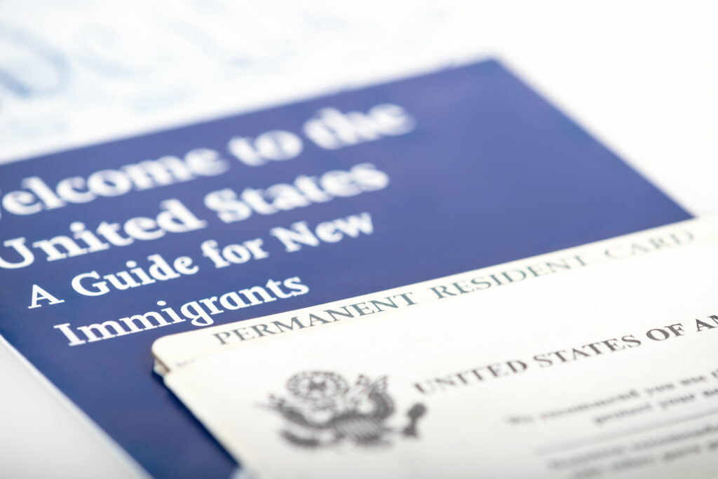 United States of America permanent resident card, green card. Immigration concept. Closeup with shallow depth of field.