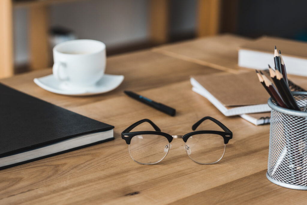 Close-up view of glasses on office table with stationery